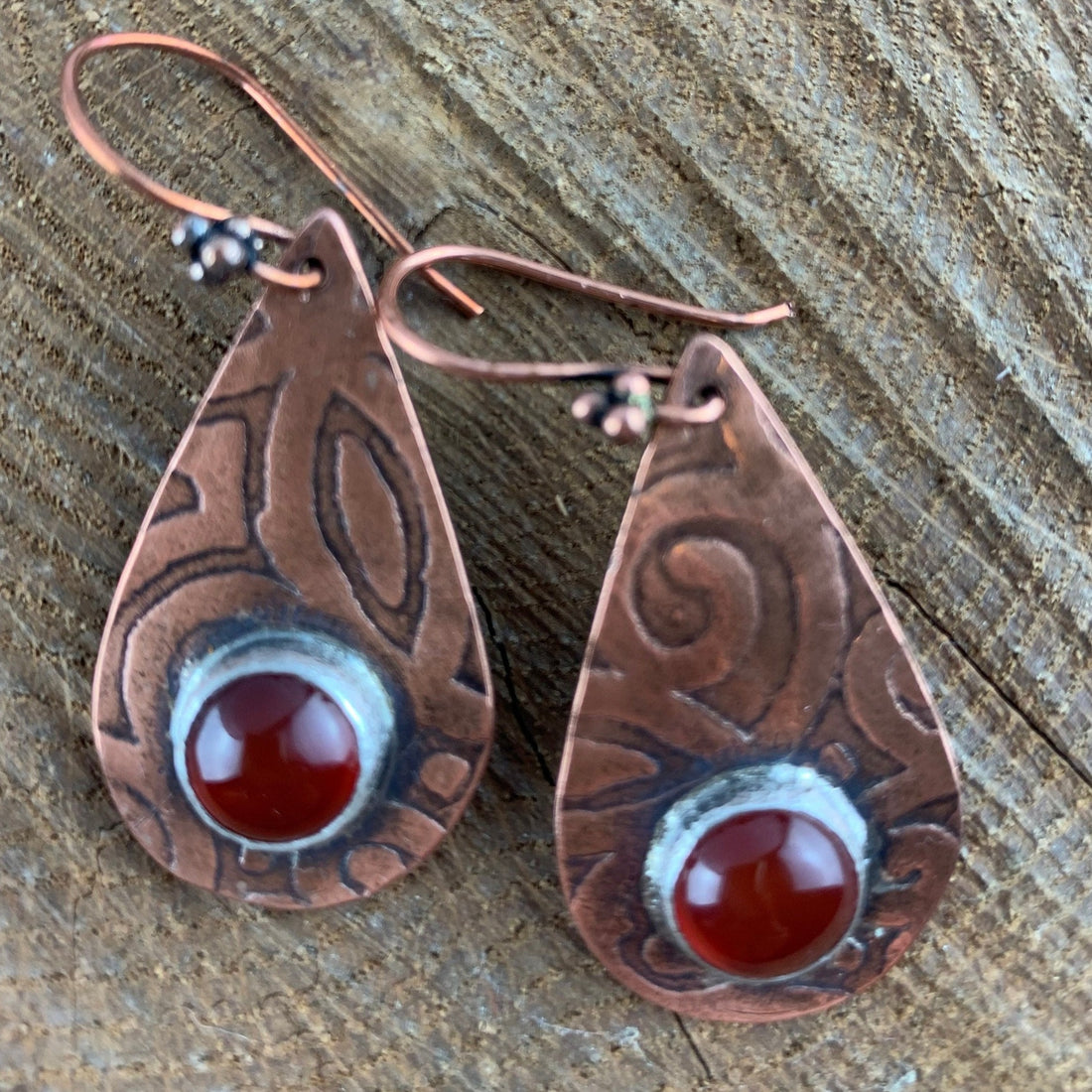 Antiqued and etched copper teardrop dangle earrings with a carnelian gemstone setting on French earwire.